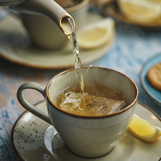 Cup of Herbal Tea Served with Biscuits