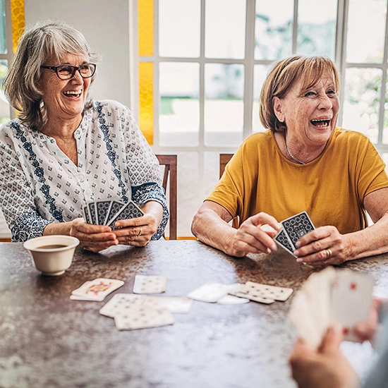 Group of people, senior people playing cards in nursing home.